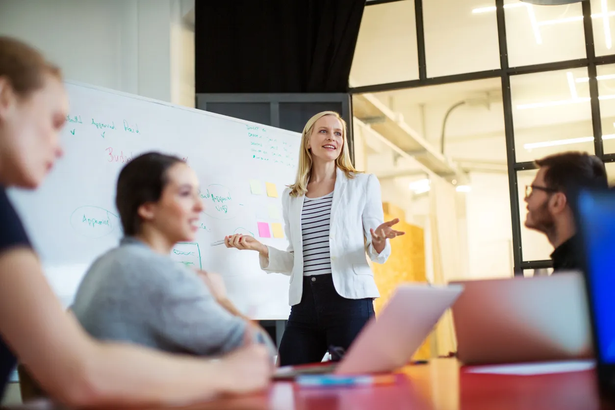 In-person and remote hybrid meeting focused on cross-functional teamwork.