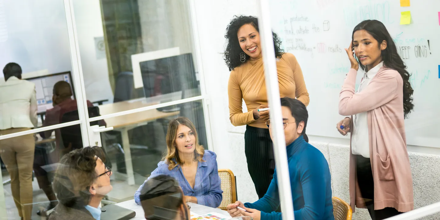 Casual brainstorming session among team members in a co-working space.