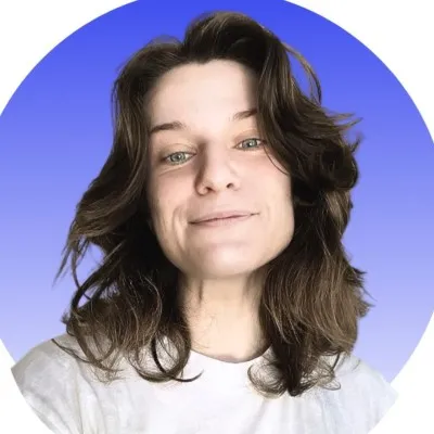 Portrait of a person with shoulder-length brown hair smiling slightly against a blue gradient background.